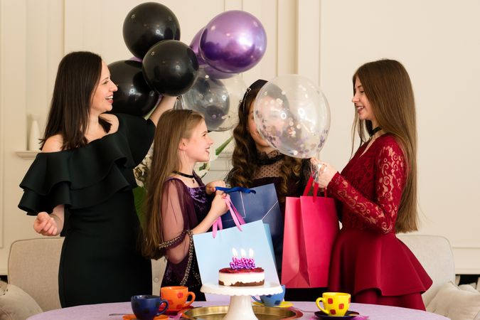 Mother, daughter, and friends enjoying birthday celebration