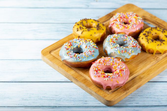 Delicious assorted colorful donuts on the table.