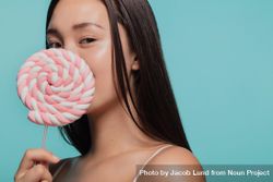 Portrait of young woman with a sugar candy lollipop 42g1eb