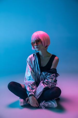 Woman sitting in sparkly silver jacket