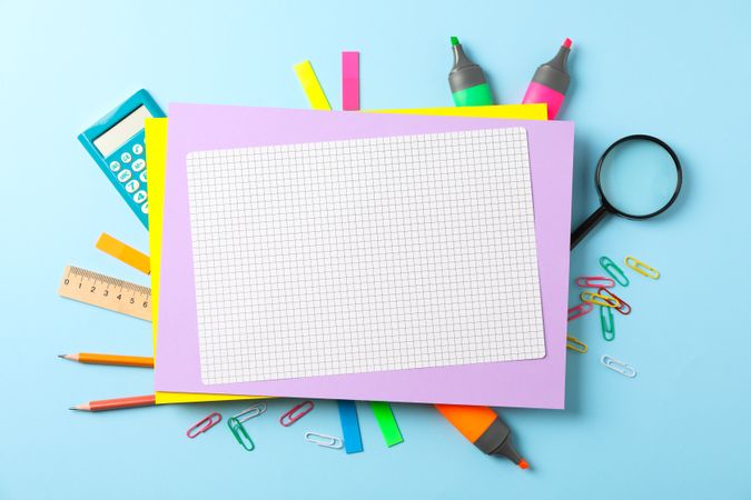Flat lay composition with school supplies on color background, space for text
