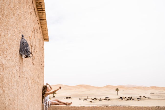 Woman on terrace against desert landscape
