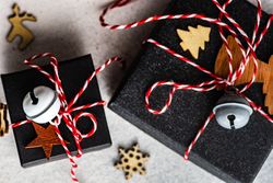 Holiday gift boxes with holiday decor on stone background with copy space