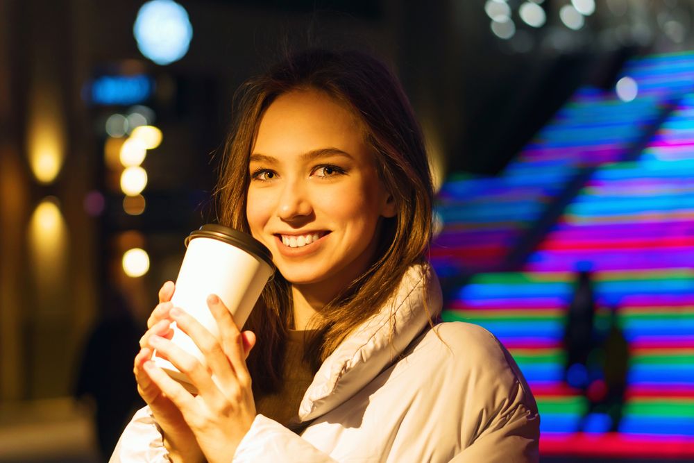 Smiling woman enjoying nightlife in city