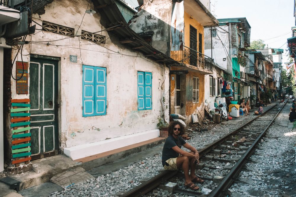 Man sitting on train rail
