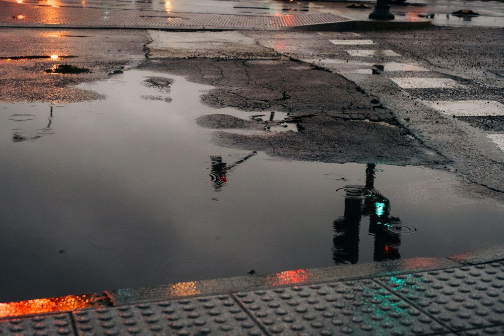 Reflection of traffic light in puddle