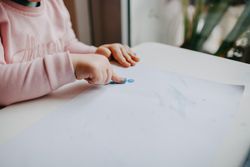 Close up of little girl’s hand while finger-painting