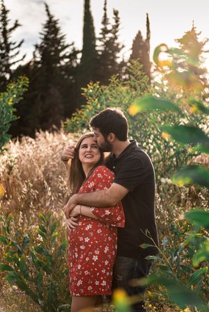 Young happy couple embracing in beautiful garden