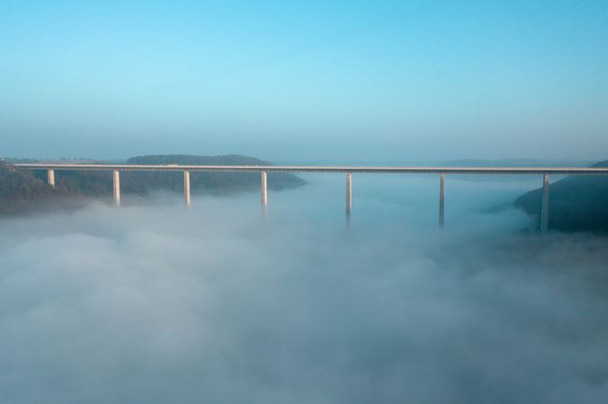 Germany's tallest bridge over dense fog, drone aerial view, at sunrise in Braunsbach, Germany