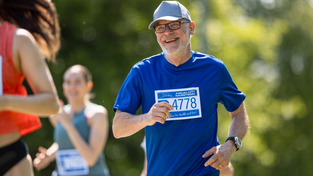 Portrait of a Mature Male Jogger Running in a Park on a Health Trail.