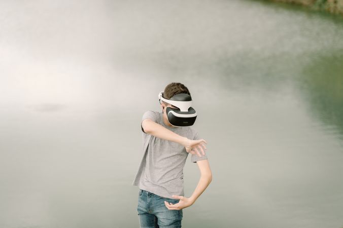 Young teenager with virtual reality glasses outdoors