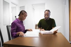 Casual Study Session at Home with Books and Conversation.