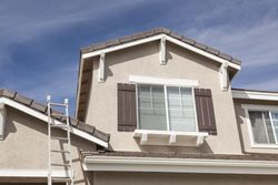 Ladder Leaning Up Against A Freshly Painted Home