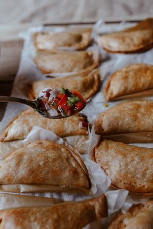Baking tray with composed freshly baked pies patty
