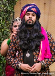 Indian man wearing a turban and woman standing right behind him 4OXoob