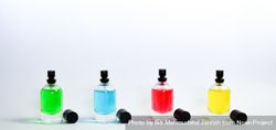 Four colorful perfume bottles in a row 4ZePoW