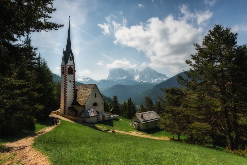 Picturesque church on green hill in forest