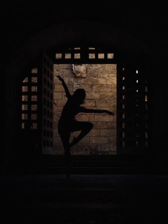 Anonymous ballet dancer in darkness