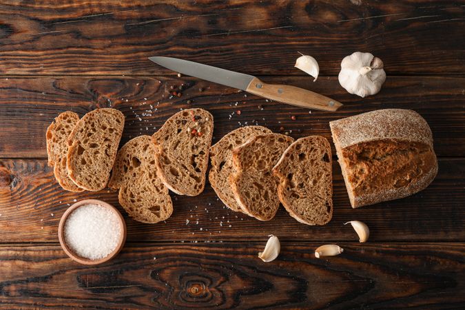 Flat lay composition with freshly baked bread on wooden background, top view and space for text