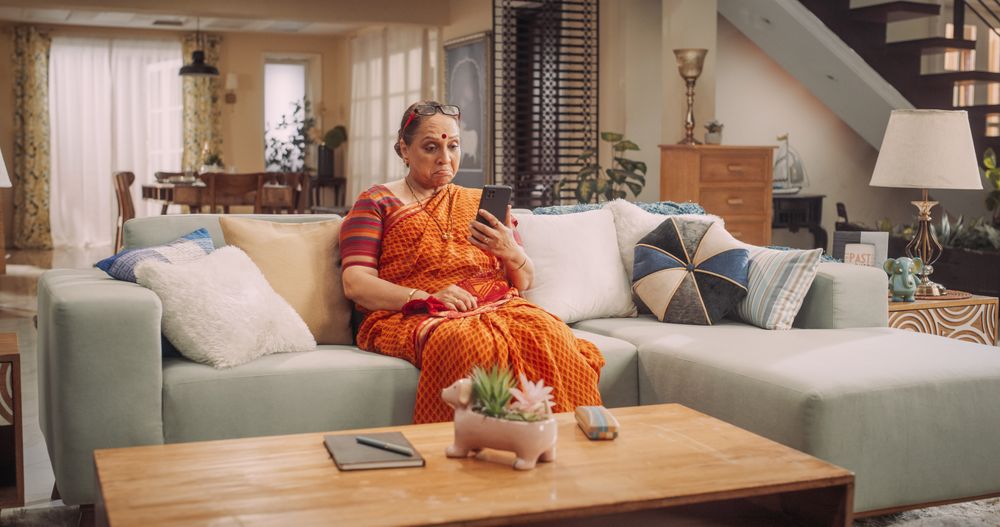 Older Indian Woman Using Smartphone at Home: Talking with Loved Ones, Relatives, Friends, Grandchildren.