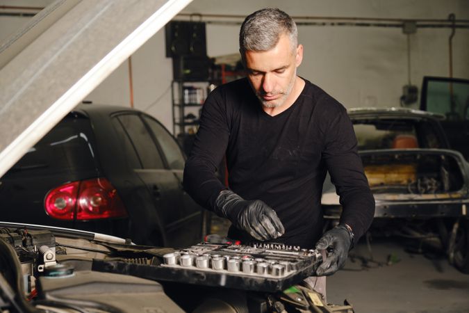 Adult man repairing car