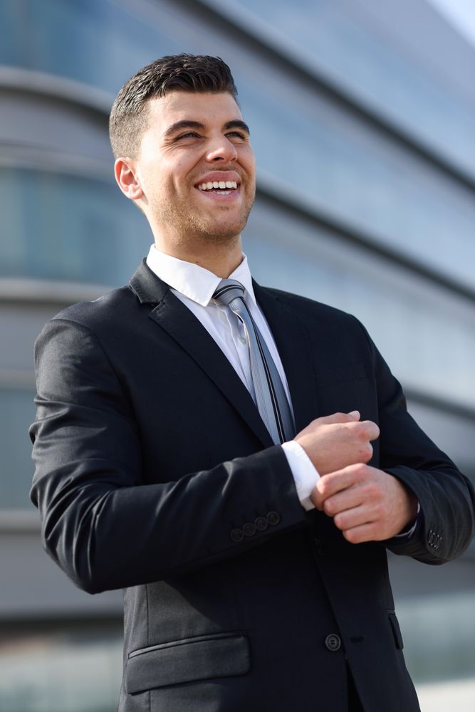 Smiling man adjusting his sleeves