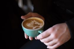 Woman holding a cappuccino