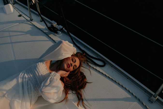 Woman in luxury dress resting on yacht