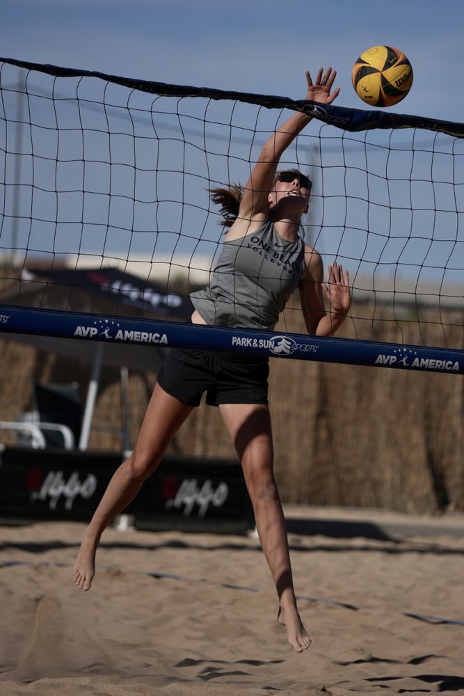 Teenage girl playing volleyball at the beach