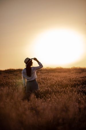 Anonymous woman walking in lavender field