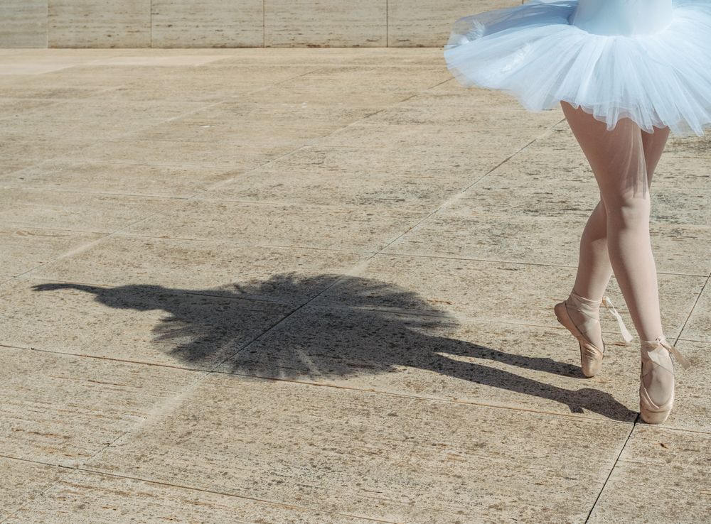 Ballerina standing on tiptoe classical position outside