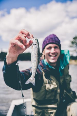 Man holding a fish and smiling