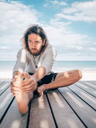 Man stretching on beach
