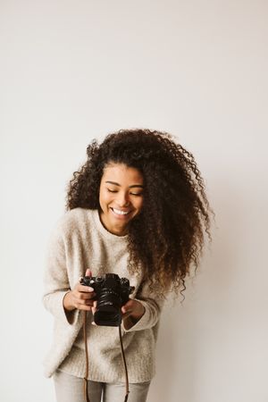 Cheerful Black woman with camera