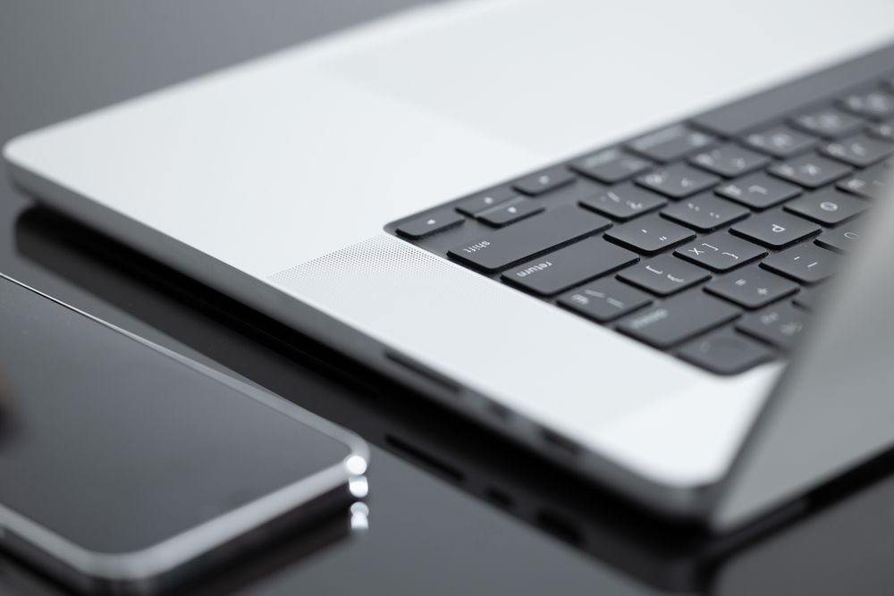 Laptop And iPhone On Desk