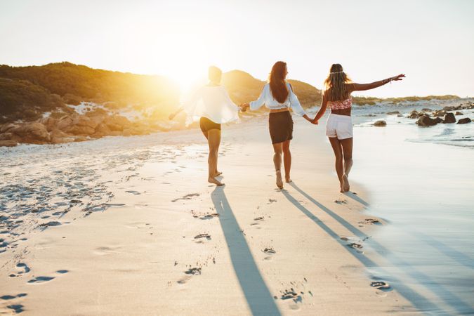 Young women strolling along a beach and enjoying vacation