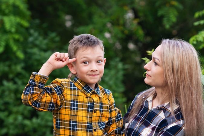 Portrait of mother spending time with son in forest