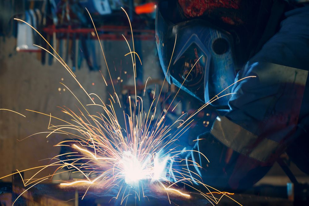 Side view of person welding iron