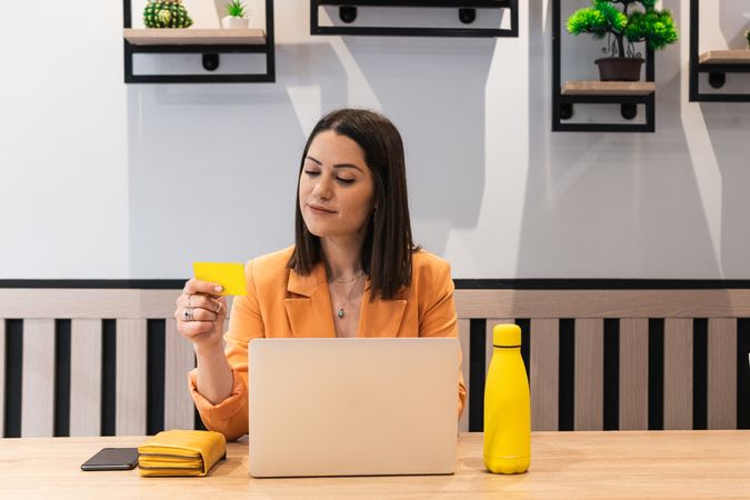 Happy woman making payment during online shopping