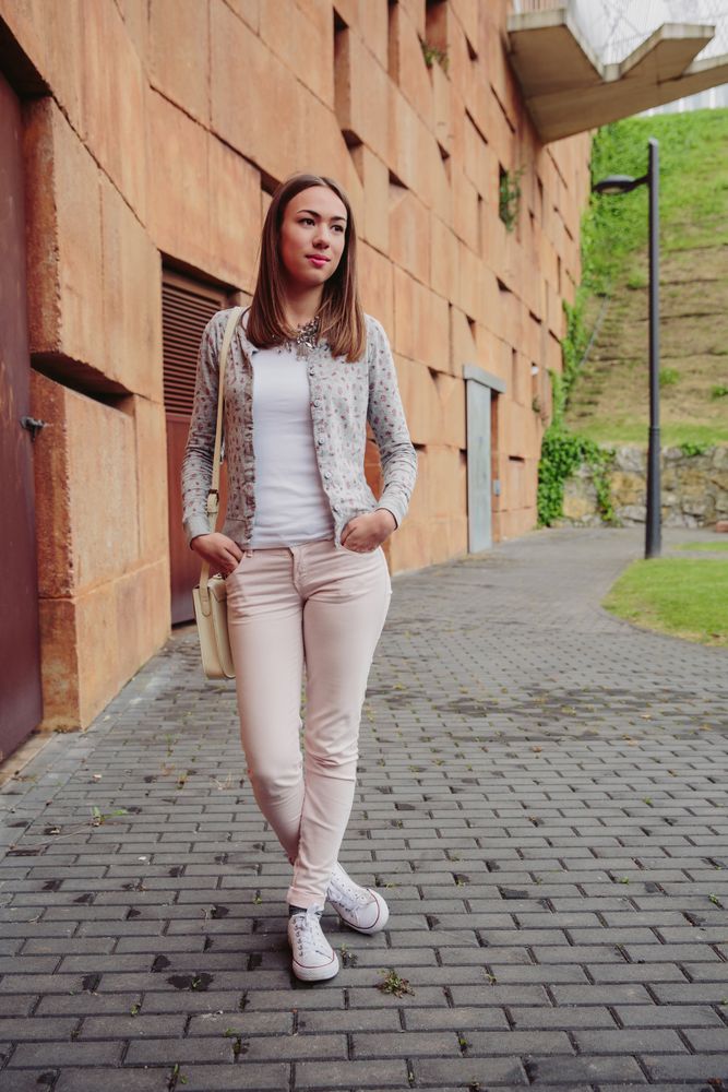 Young woman standing on street with hands in pocket