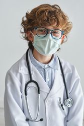 Boy doctor in medical mask and uniform with stethoscope