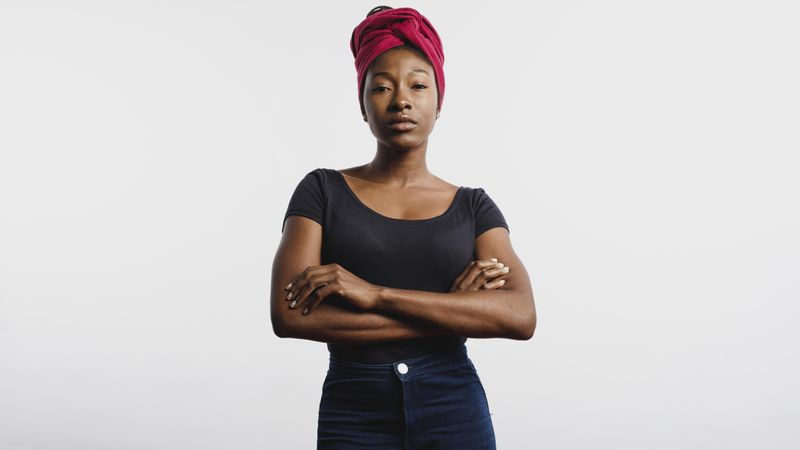 Portrait of Black woman standing with her arms crossed