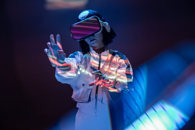 Woman touching air in VR glasses