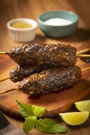 Beef kafta on the wooden board. Kafta, Traditional Arabic cuisine.