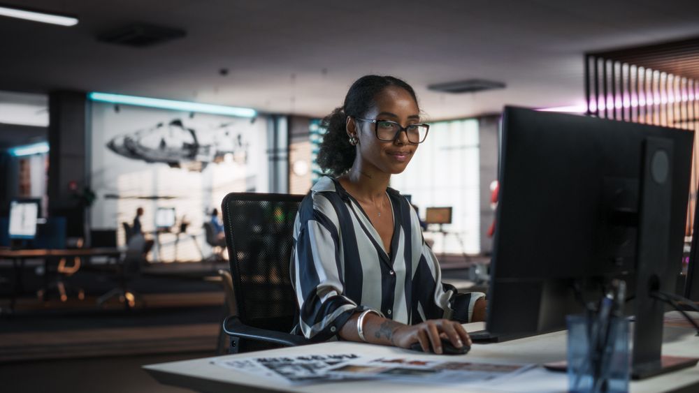 Young Black Woman Working on Desktop Computer in Creative Office.