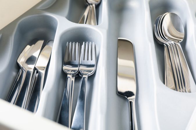 Set of different cutlery on whole background, close up