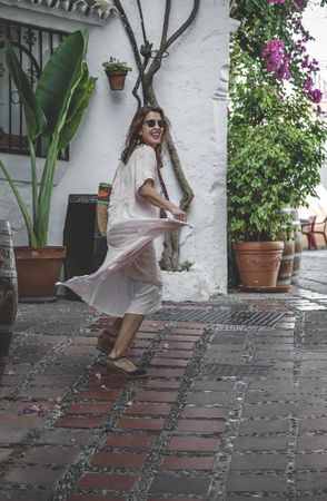 Happy female walking on side street in town