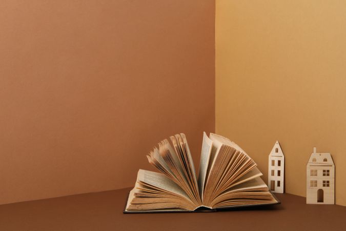 A children's book with toys on a beige background.