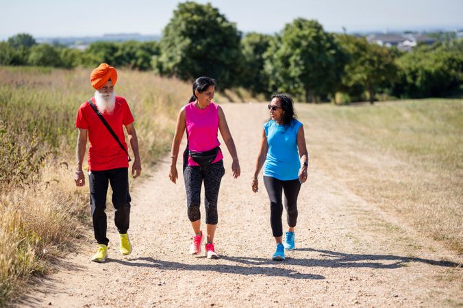 Mature Sikh family going for a stroll in field