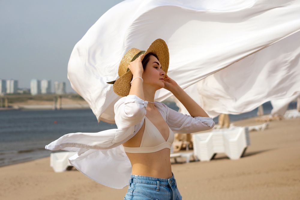 Woman on beach on windy day